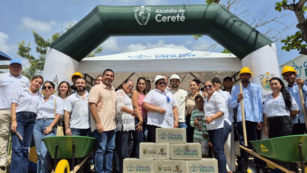 Funcionarios, trabajadores y miembros de la comunidad posan durante un acto institucional de inicio de obra, junto a bloques de construcción, carretillas y herramientas frente a la sede del Camu del Prado.